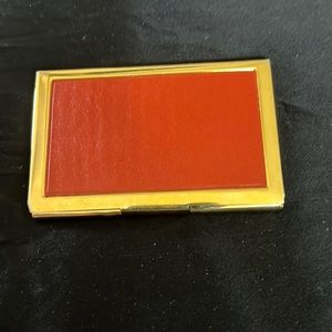 Gold metal case w/ orange leather design. Store business / credit cards.